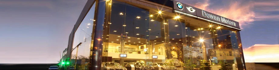 Dewan Motors BMW showroom illuminated at dusk